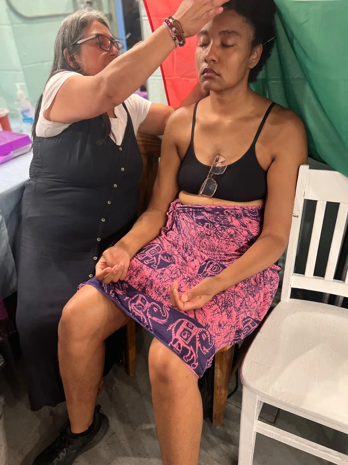 Practitioner supporting a seated participant