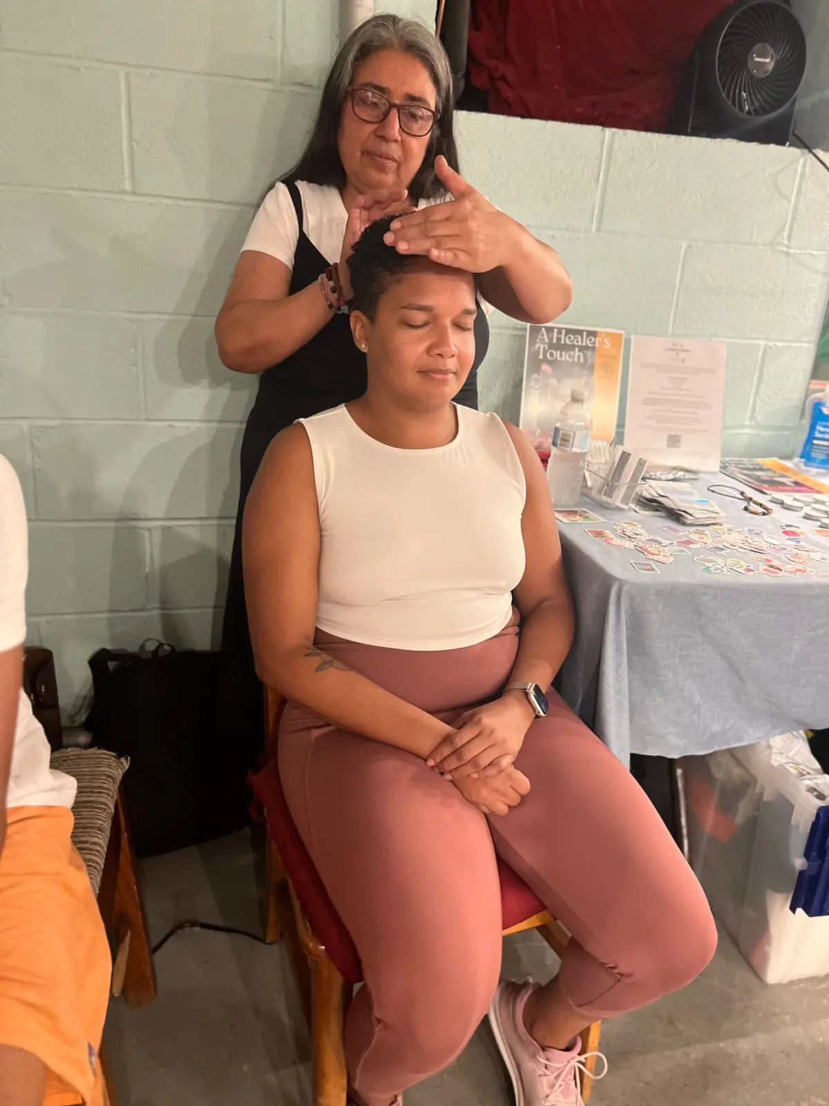 Practitioner working with a seated participant