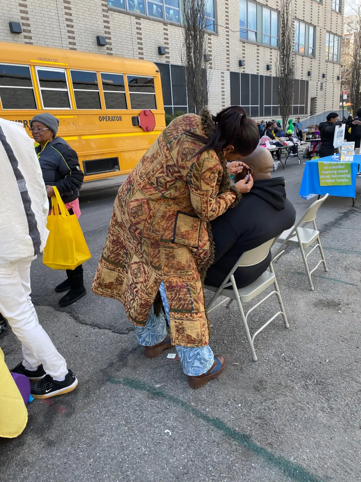 Practitioner providing care to a seated attendee