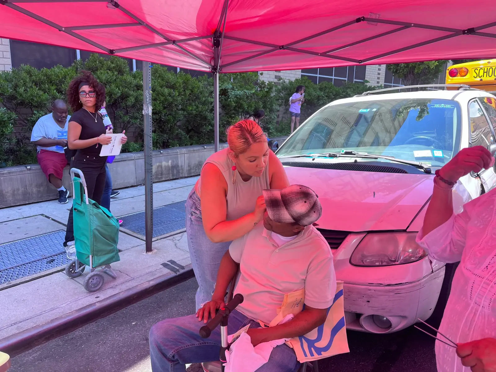 Ear wellness service under a red tent