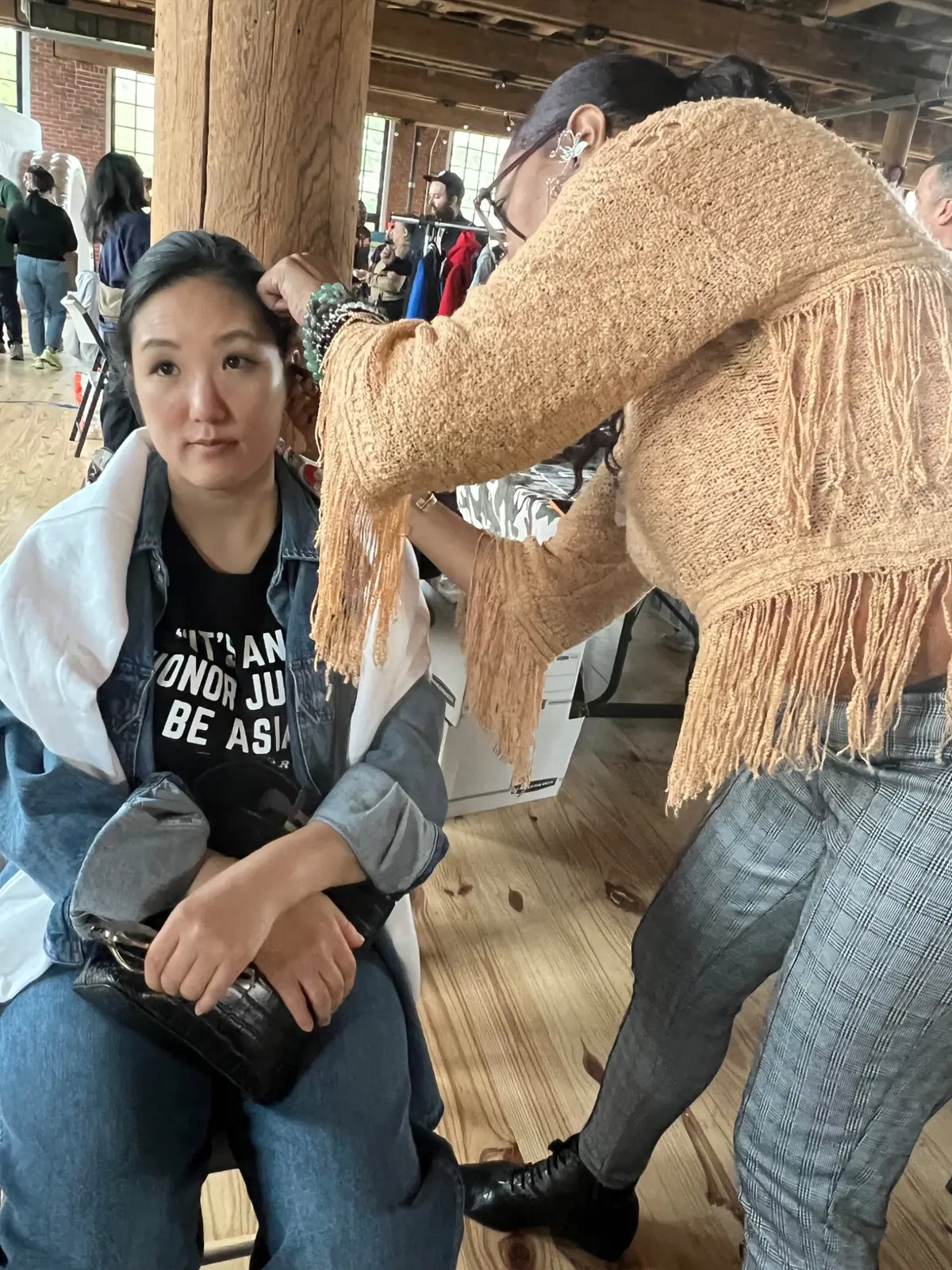 Practitioner working with a participant at an arts event